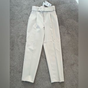 Pants with fabric-covered belt